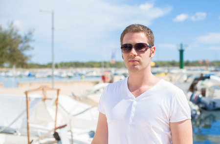 Man portrait against of the pier with yachts.の写真素材