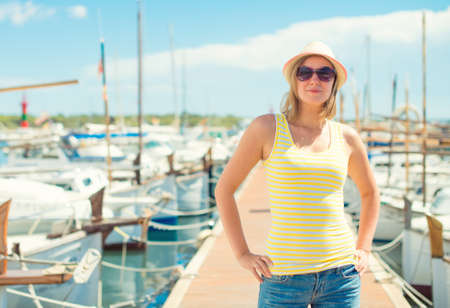 Woman portrait against of the pier with yachts.の写真素材