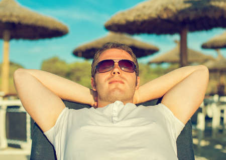 Man sunbathing on the beach vacation.の写真素材