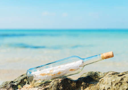 Bottle with message on the beach. Space for your text.の写真素材
