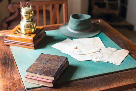 Old books lying on the dusty table.