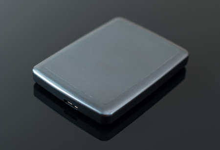 External usb hard drive on the black table.の写真素材