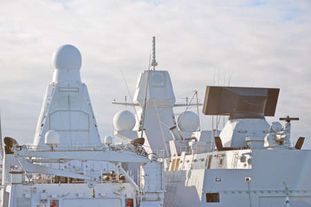 Two white naval ships with radar and other communications.の写真素材