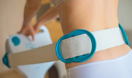 Woman doing massage with electric massager.の写真素材