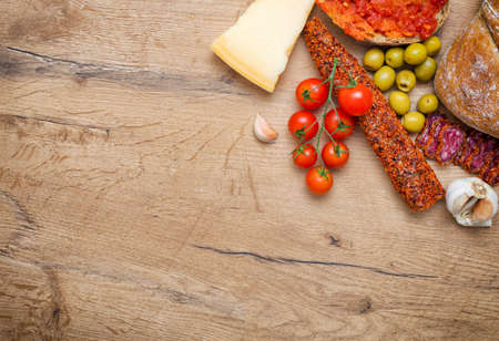 Bruschetta with tomato paste tomatoes cheese olives garlic and fuet. Place for text.の写真素材