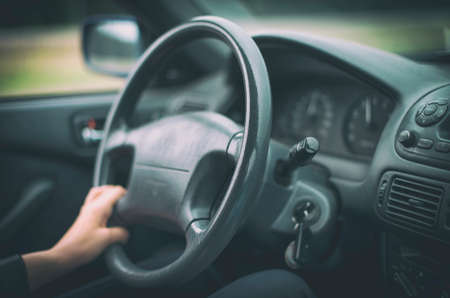 Woman's hand driving a car. Unrecognizable person.の写真素材