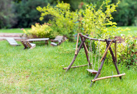 Swing and furniture in the garden.の写真素材