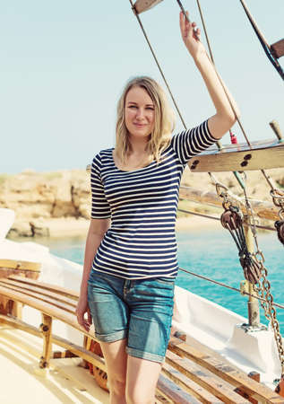 Young pretty woman on the motor boat.の写真素材