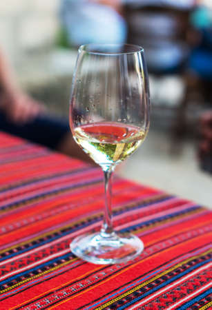 Glass with white wine on the table.の写真素材