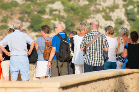 Group of tourists watching the sights. Back. view.の写真素材