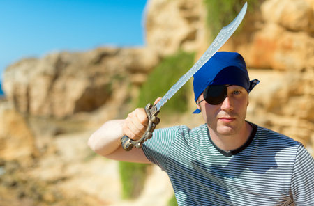 Male pirate with sword. Place for your text.