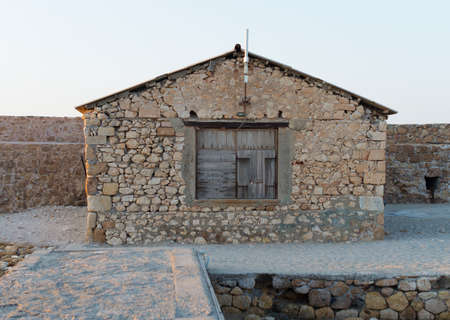 Ancient fisherman's house on the stone pier.の写真素材