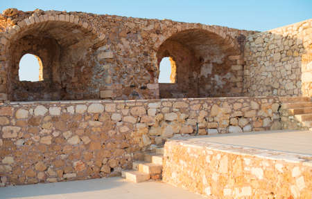 Ancient stone fortification with windows and ladder.の写真素材