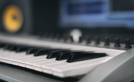 Midi keyboard. Home recording studio with professional monitors.