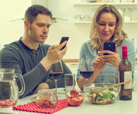 Young couple having dinner at home. Modern dating.の写真素材
