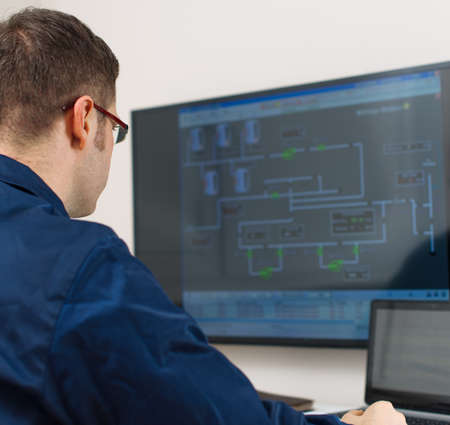Male worker in glasses in thermal plant's control room.の写真素材