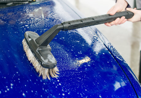 Car wash using special brush with soap.