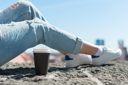 Woman relaxing with cup of coffee in the old town.