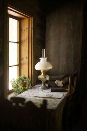 Ancient house interior with lamp and table.の写真素材