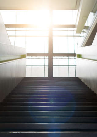 Stairs up inside the building and sun glare.の写真素材
