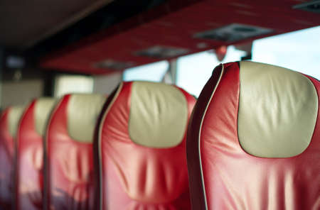 Empty red leather seats in tourist bus.の写真素材