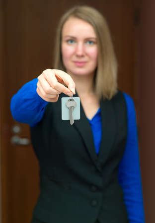 Hotel receptionist offering key from room.の写真素材