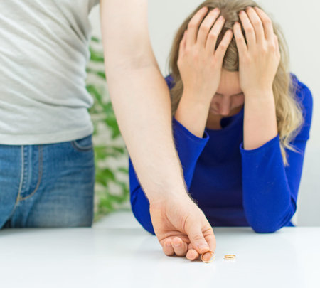 Divorce concept. Man returning wedding ring to his wife.