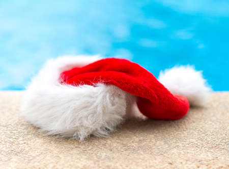 Red christmas hat near the pool.の写真素材