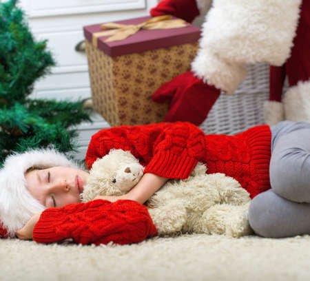 Santa Claus delivering presents while kids are sleeping.の写真素材