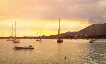Yachts and boats in the bay at sunset.の写真素材