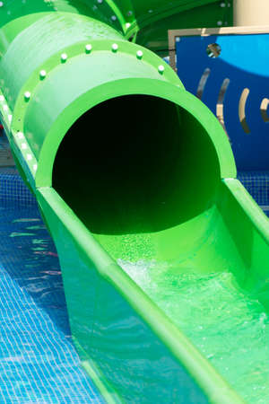Green water slide in waterpark resort.の写真素材