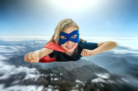 Superhero kid flying across the planet.の写真素材