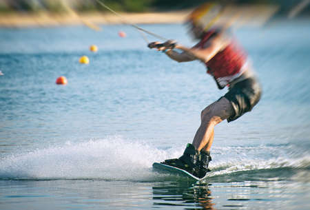 Man on wakeskate doing tricks. Cable Wakeboard.の写真素材