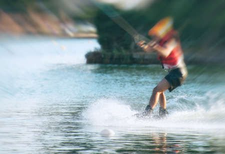 Man on wakeskate doing tricks. Cable Wakeboard.の写真素材