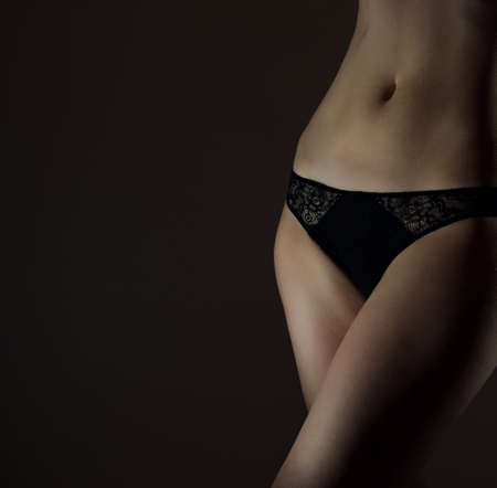 Front view of sexual female body in black panties. Space for textの写真素材