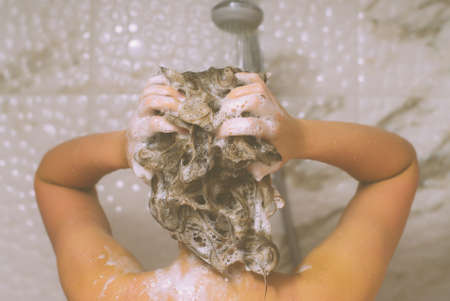 Woman washing her head in the shower.の写真素材