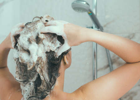 Woman washing her head in the shower.の写真素材
