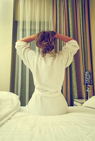 Woman waking up in her bed. Back view.の写真素材