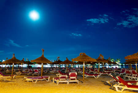 Night beach with sun loungers in Alcudia, Mallorca.の写真素材