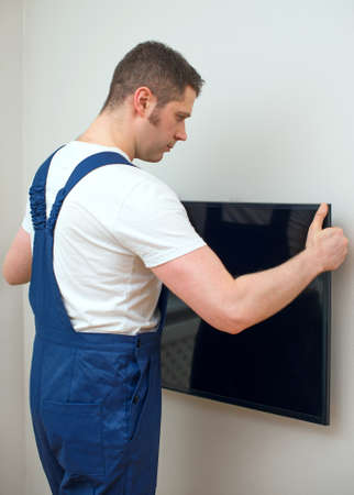 Man mounting TV on the wall.の写真素材