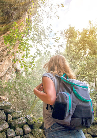 Woman with backpack traveling in the mountains.