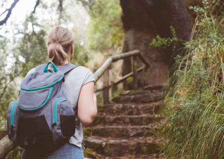 Woman with backpack enjoying nature. Back view.の写真素材