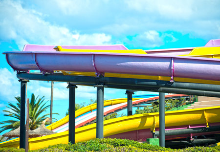 Colorful plastic water-slides in amusement park.