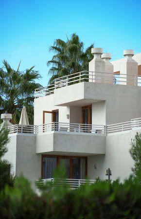 Portrait of tropical apartment building with trees.の写真素材