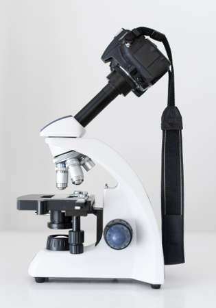 DSLR Camera attached with adapter to microscope.の写真素材