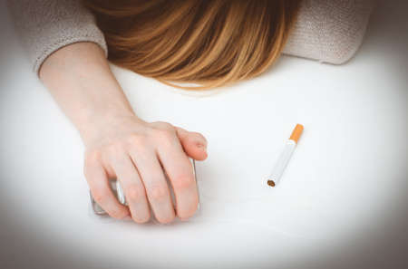 Drunk woman sleeping on the table. Female alcoholism.の写真素材