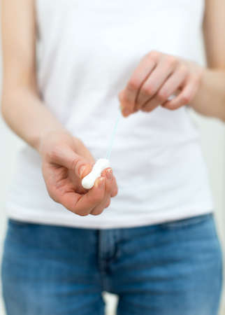 Woman holding tampon in her hands.の写真素材