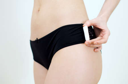 Woman holding tampon in her hands.の写真素材