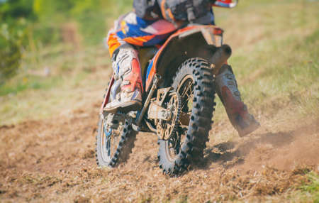 Professional motocross rider on the road. Back view.の写真素材