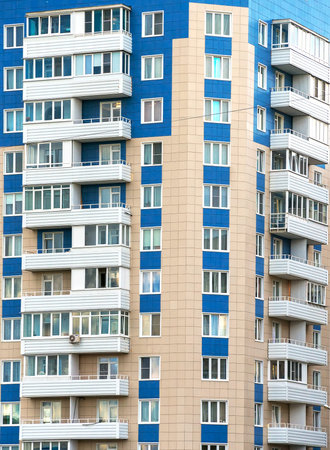 Portrait of apartment building with balconies.